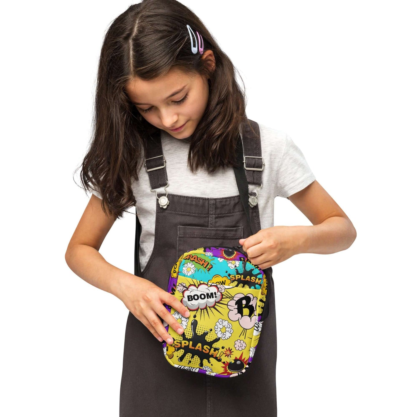 Whether you're a teen looking to add some fun to your outfit or a mom who loves playful accessories, the Comic Cross Body Bag is the perfect way to carry your essentials in style.