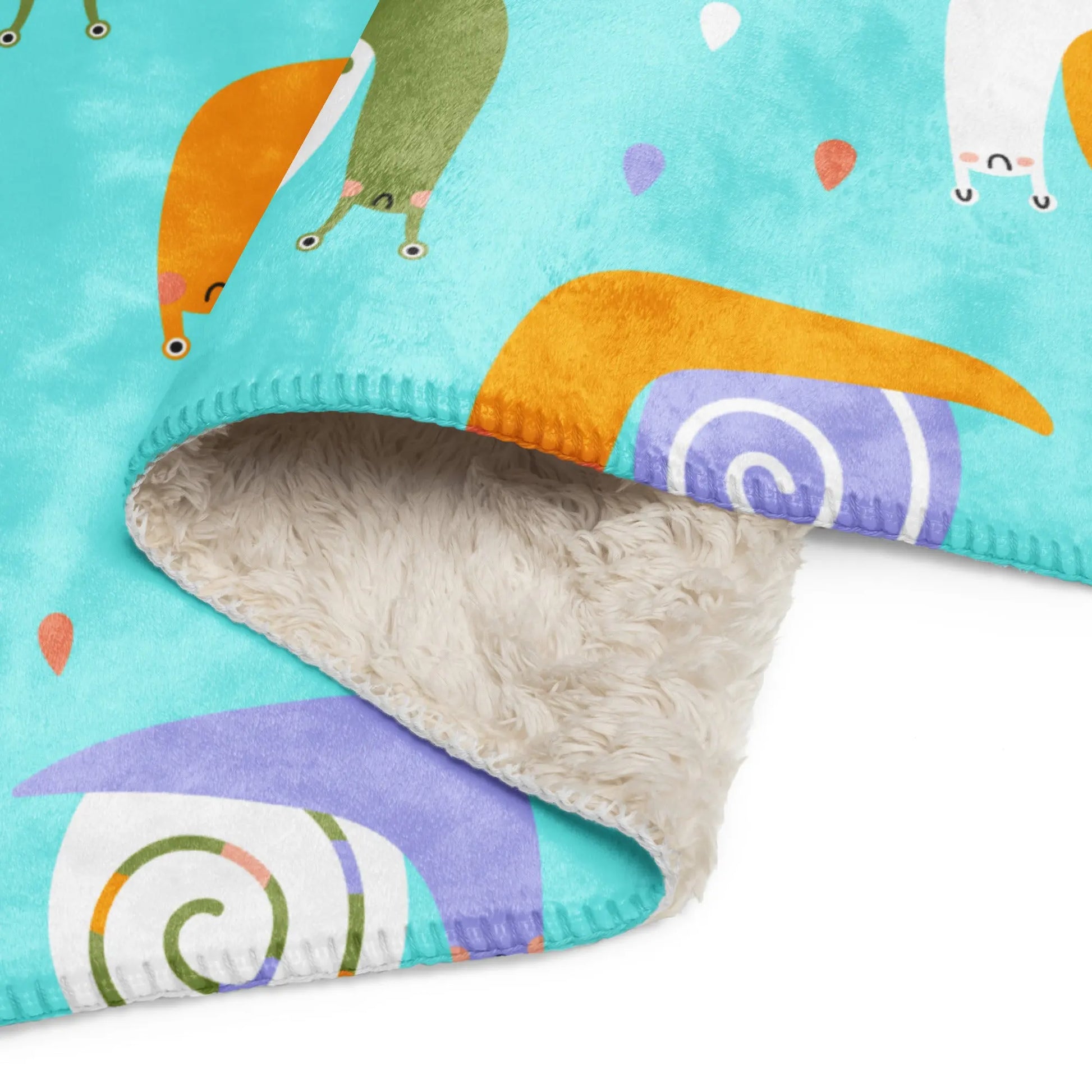 Adorable blanket features a charming baby snail pattern that turn bedtime into a whimsical adventure. SHOP Now at the Wishful Fish KIDS